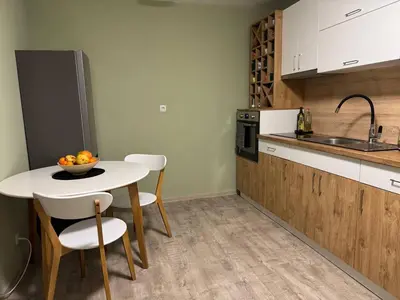 a kitchen with a table and a bowl of fruit on it at Olive Apartment with terrace B100 in Grand Resort Pamporovo in Pamporovo