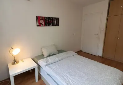 a small bedroom with a bed and a table at Niko's 2 Bedroom Central Apartment in Sofia