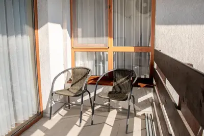 two chairs and a table on a balcony at Gondola Apartments Lux in Bansko
