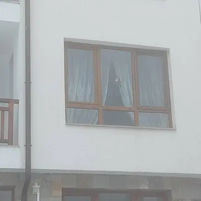 a window on the side of a white building at Семи гарден in Borovets