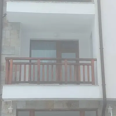a wooden bench sitting in front of a window at Семи гарден in Borovets