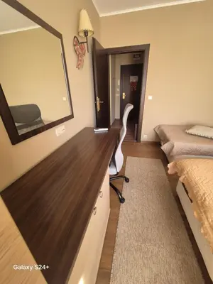 a room with a mirror and a dresser and a bed at Apartment at Dream Bansko in Bansko
