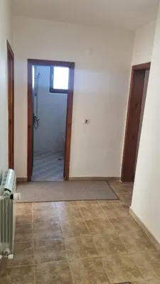 an empty room with a shower and a door to a bathroom at Банско Апартментс in Bansko