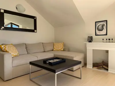a living room with a couch and a fireplace at Central Art Apartment in Bansko with Mountain View in Bansko