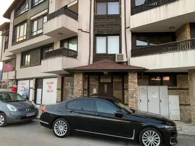 a black car parked in front of a building at Central Art Apartment in Bansko with Mountain View in Bansko