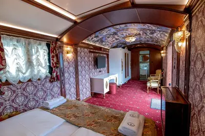 a room with a bed in a train car at Glamping Alliance Hotel in Plovdiv
