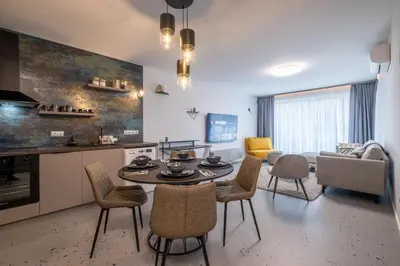 a kitchen and living room with a table and chairs at Emirates Luxury Apartment Free Parking Terrace in Sofia