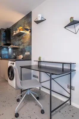 a black desk and a chair in a room at Emirates Luxury Apartment Free Parking Terrace in Sofia