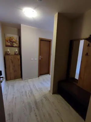 an empty living room with a mirror and a door at Апартаменты Grand Ressort in Pamporovo