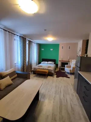 a living room with a bed and a couch at Апартаменты Grand Ressort in Pamporovo