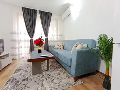a living room with a blue couch and a table at Diamond Heights apartament in Bansko