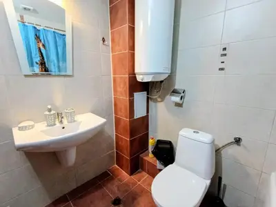 a bathroom with a toilet and a sink at Diamond Heights apartament in Bansko
