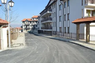 an empty street next to some apartment buildings at Diamond Heights apartament in Bansko