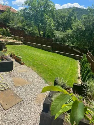 a backyard with a fence and a yard with grass at Къща за гости НОВЕ in Terziysko