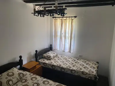 a bedroom with two beds and a window at Къща за гости НОВЕ in Terziysko