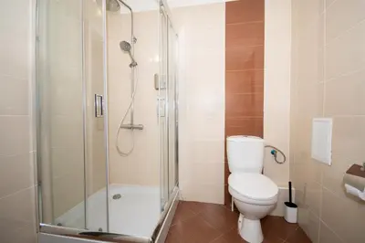 a bathroom with a toilet and a glass shower at !!!1min From The Lift I Luxury Studio In Pirin Palace in Bansko