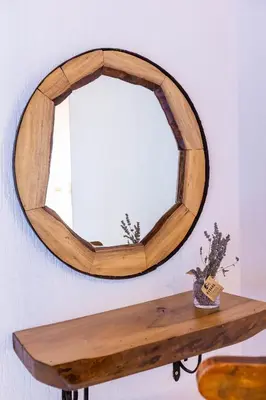 a wooden mirror on a wall with a wooden table at Комплекс Конна база Асгард in Golem Tsalim