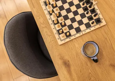 a chess board and a cup of coffee on a table at Luxury Studio Living High-End Amenities and Great Location by Flat Mаnager in Sofia
