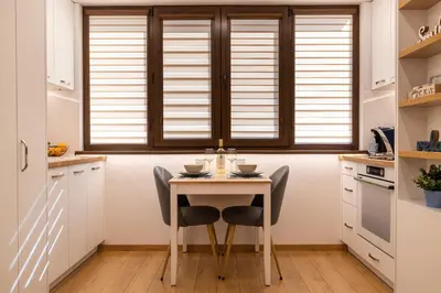 a kitchen with a table and chairs and a window at Luxury Studio Living High-End Amenities and Great Location by Flat Mаnager in Sofia