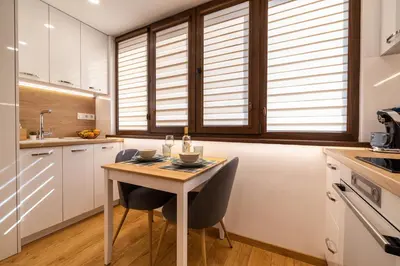 a kitchen with a table with two chairs and a sink at Luxury Studio Living High-End Amenities and Great Location by Flat Mаnager in Sofia