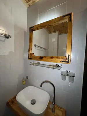 a bathroom with a sink and a mirror at Nicole Hotel & Restaurant in Samokov