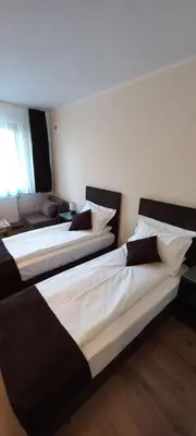 two beds sitting in a room with at Nicole Hotel & Restaurant in Samokov