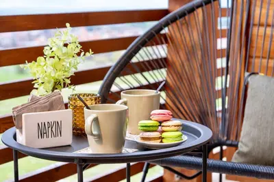 a tray with cups and donuts on a table at Peaceful Condo w/ Amazing View in Bansko