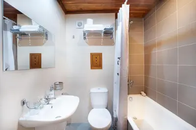 a bathroom with a toilet and a sink and a tub at Peaceful Condo w/ Amazing View in Bansko