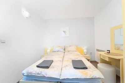 a bed with two towels on it in a bedroom at Snow Legend Apartment with terrace in Bansko