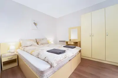 a large bed in a room with white cabinets at Snow Legend Apartment with terrace in Bansko