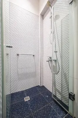 a bathroom with a shower with a glass door at Студио Римски Стадион in Plovdiv