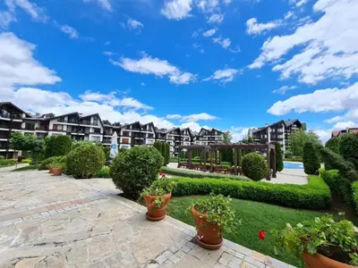 a courtyard at a apartment complex with potted plants at Aspen Golf Resort and SPA in Bansko