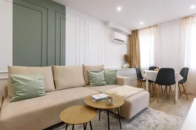 a living room with a couch and a table at Apartment BonBon next to Gondola in Bansko