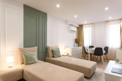 a hotel room with two beds and a dining room at Apartment BonBon next to Gondola in Bansko