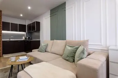 a living room with a couch and a table at Apartment BonBon next to Gondola in Bansko
