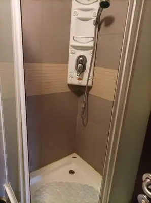 a shower stall with a camera and a toilet at Apartment 2 Detelina Residence in Bansko