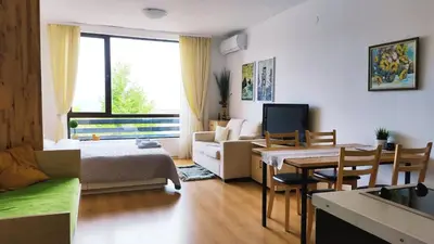 a living room with a bed and a dining room at Aspen studio Mountain retreat at Aspen Resort Golf Ski & Spa in Razlog