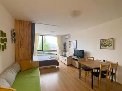 a living room with a couch and a table at Aspen studio Mountain retreat at Aspen Resort Golf Ski & Spa in Razlog