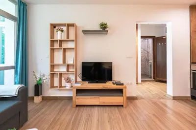 a living room with a television on a table at Modern and Cozy 1BDR Apartment in the City Center in Sofia