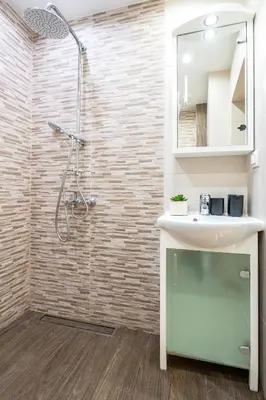 a bathroom with a sink and a shower at Modern and Cozy 1BDR Apartment in the City Center in Sofia