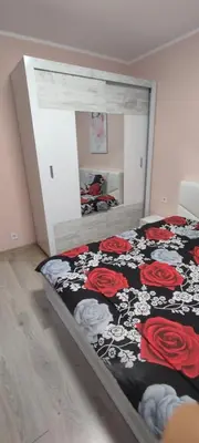 a bedroom with a bed with a black and red blanket at Luxury and stylish apartmen, metro station Obelya in Sofia