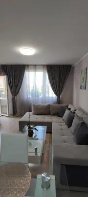 a living room with a couch and a table at Luxury and stylish apartmen, metro station Obelya in Sofia