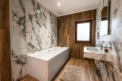 a bathroom with a white tub and a sink at Beluga Guest House in Velingrad