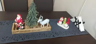 a table topped with figurines of santa claus and a christmas tree at Borovets Gardens Studio Raya in Borovets