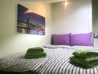 a bedroom with a bed with green towels on it at The Backpacker's Spot - Bus & Railway Station Gem by Flat Mаnager in Sofia
