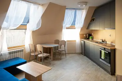 a kitchen and dining room with a table and chairs at Design Loft in the City Center in Sofia