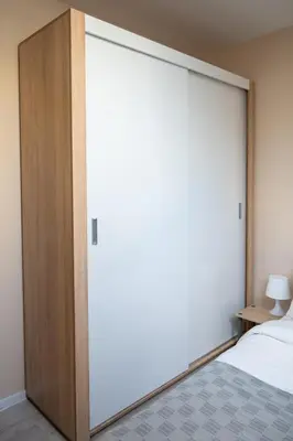 a large sliding door in a bedroom with a bed at Design Loft in the City Center in Sofia