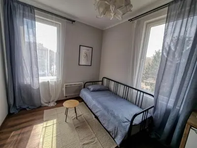 a bedroom with a bed and two large windows at Cozy Apartment in Sofia Center in Sofia