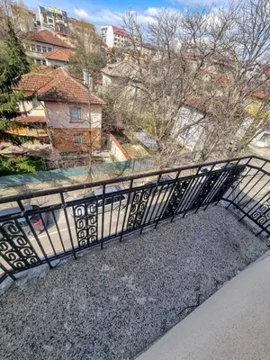 a black bridge over a river with buildings in the background at Cozy Apartment in Sofia Center in Sofia