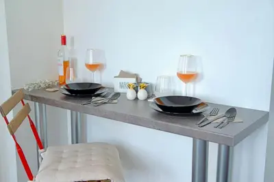 a table with two black plates and glasses of wine at Cozy 1-Bedroom flat in the very Center of Sofia in Sofia